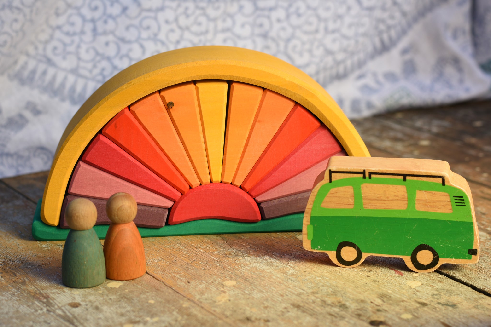 The Glückskäfer Yellow Sunray Arch in a simple small world play scene with the Lanka Kade camper van and Grapat Nins. 