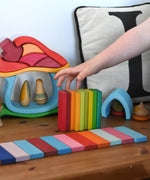 The Glückskäfer 60 Tower Building Slats laid out in a line to create a rainbow coloured road.