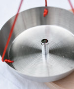 Close up of a weight on one side of the Glückskäfer balance with weights children's weighing scales toy.  