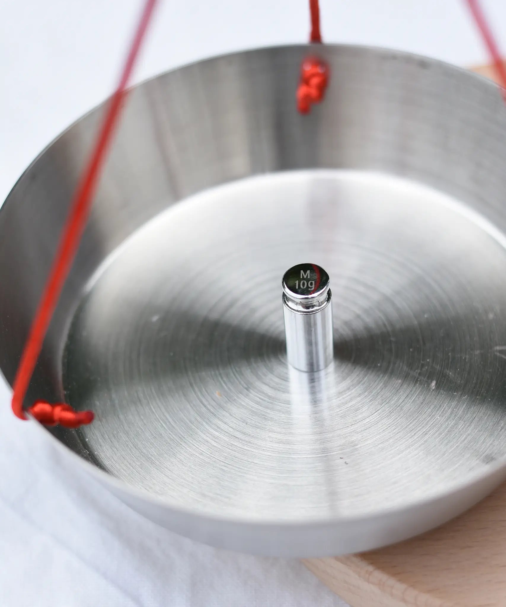 Close up of a weight on one side of the Glückskäfer balance with weights children's weighing scales toy.  