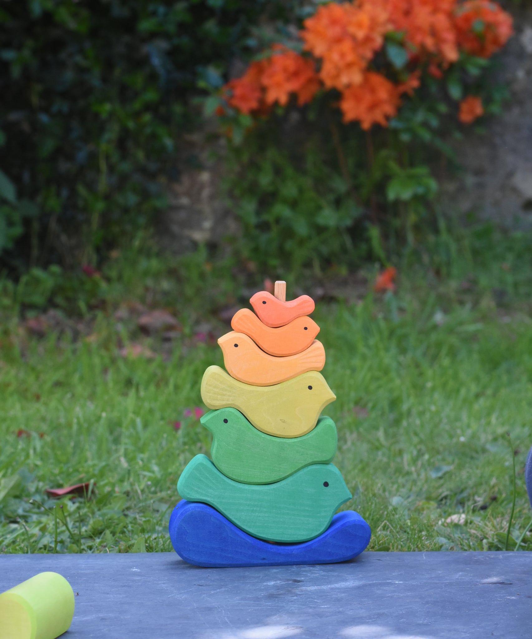 The Glückskäfer Bird Stacker placed on a slate surface outdoors. 