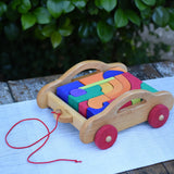 Gluckskafer carriage wooden toy block set. A natural wood pull along car with 17 colourful blocks.