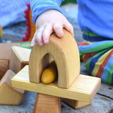A child playing with the blocks from the Glückskäfer 17 Large Natural Blocks Set.