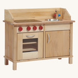 The wooden play kitchen base by Gluckskafer, made from FSC wood with a stove, oven, and sink play area.