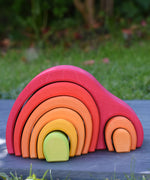 The Glückskäfer Red 8 Piece Arch House shown on a slate surface outdoors. 