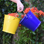 Glückskäfer Yellow and blue Metal Buckets in a child's hand
