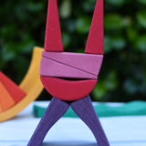Blocks from the Glückskäfer wooden stacking sunray arch in yellow purple used to create a cat shaped stack.