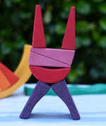 Blocks from the Glückskäfer wooden stacking sunray arch in yellow purple used to create a cat shaped stack.