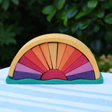 Glückskäfer wooden stacking sunray arch in yellow purple placed on a table outdoors. 