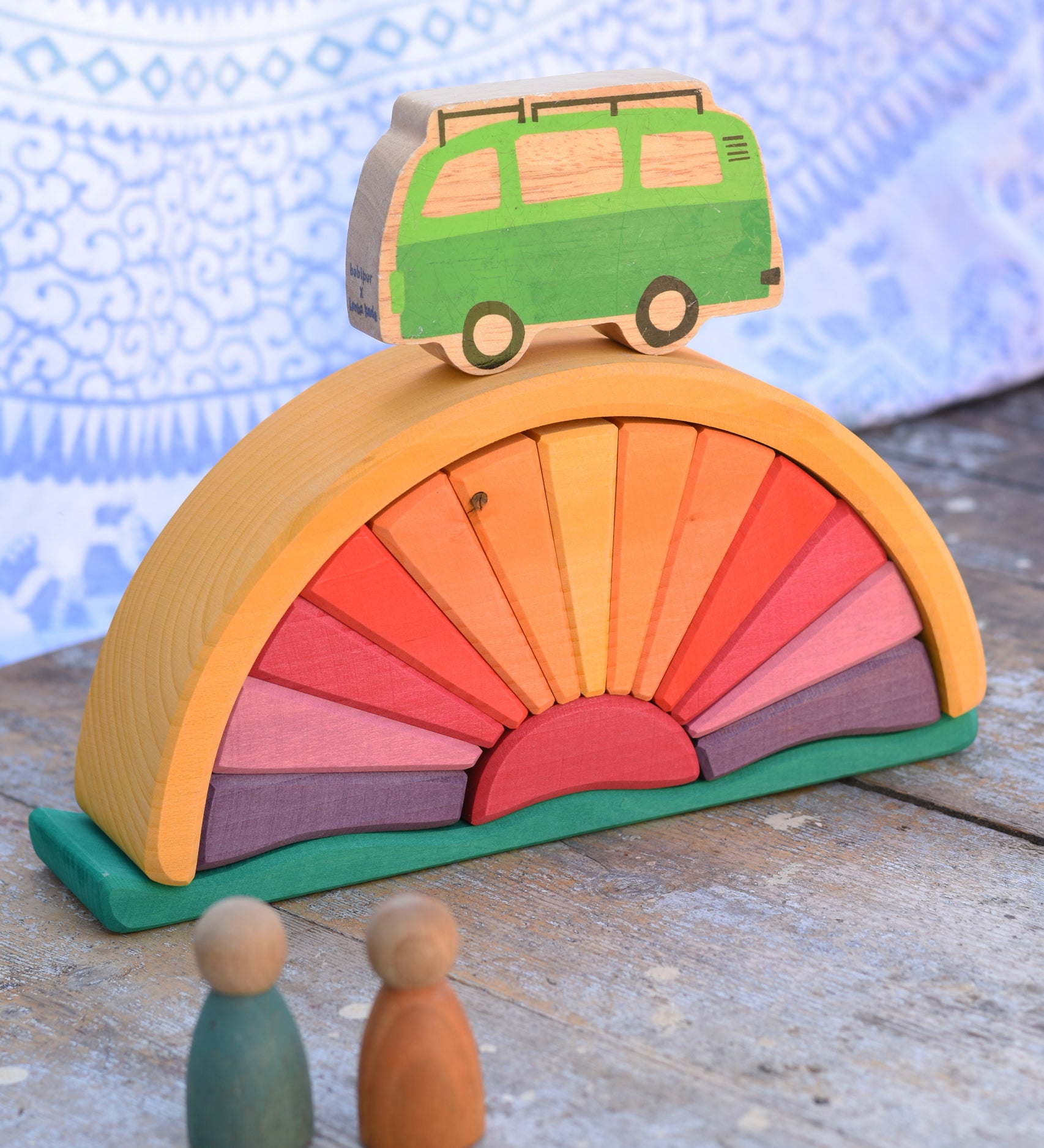 A Glückskäfer Yellow Sunray Arch in a simple small world play set up with Grapat Nins and a Lanka Kade camper van.