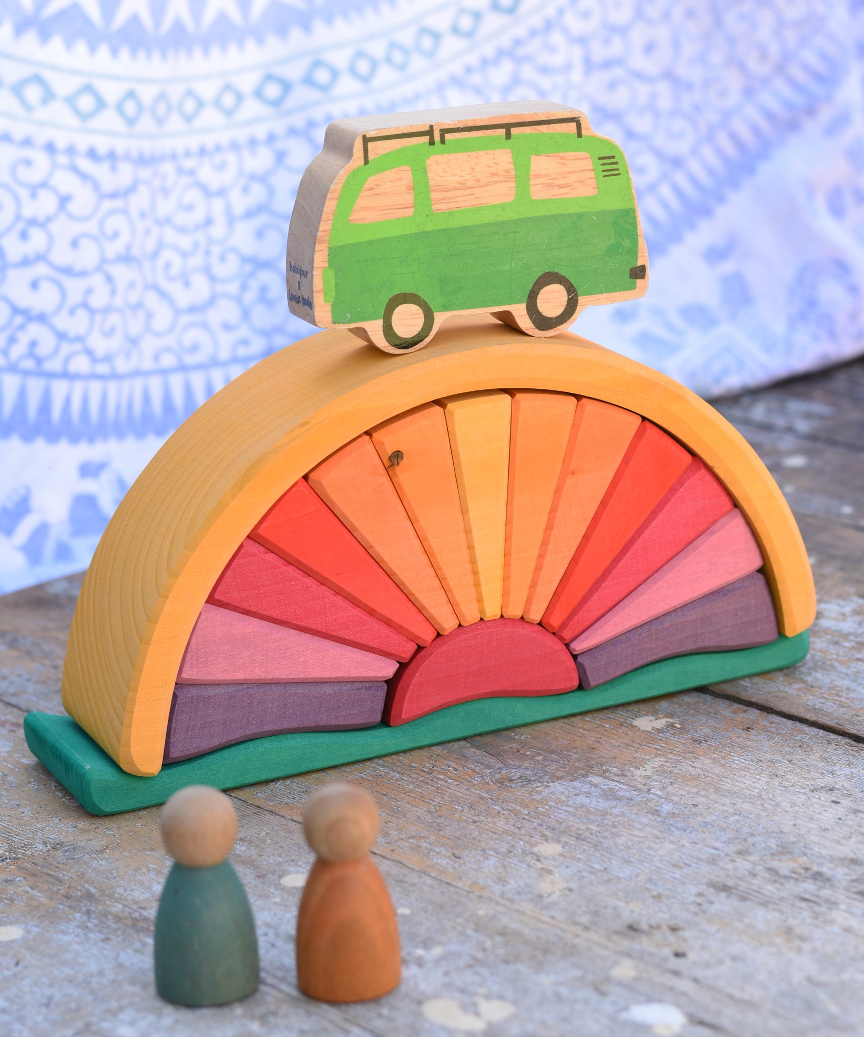 A Glückskäfer Yellow Sunray Arch in a simple small world play set up with Grapat Nins and a Lanka Kade camper van.