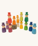 Grapat 12 Magos wooden peg dolls with top hats in a rainbow of 12 colours. These wooden toys are part of a wide range of open ended toys available at Babipur.  