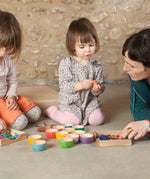 Two children and an adult playing with the Grapat 12 Rainbow Wooden Sorting Bowls. These Grapat bowls are part of a big range of open ended wooden toys available at Babipur. 