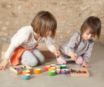 Two children kneeling down playing with the Grapat 12 Rainbow Wooden Sorting Bowls. These Grapat bowls are part of a big range of open ended wooden toys available at Babipur. 