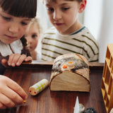 Children playing with the wooden Tio log character. One of the gifts included in the Grapat 2026 advent calendar available at Babipur.