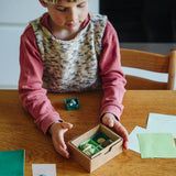 Child playing with one of the gifts included in the Grapat 2026 advent calendar available at Babipur.