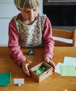 Child playing with one of the gifts included in the Grapat 2026 advent calendar available at Babipur.