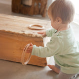 Child playing with the Grapat 3 Big wooden Hoops toys. 