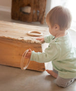 Child playing with the Grapat 3 Big wooden Hoops toys. 