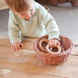 Child playing with Grapat 3 little wooden hoops loose parts toy.