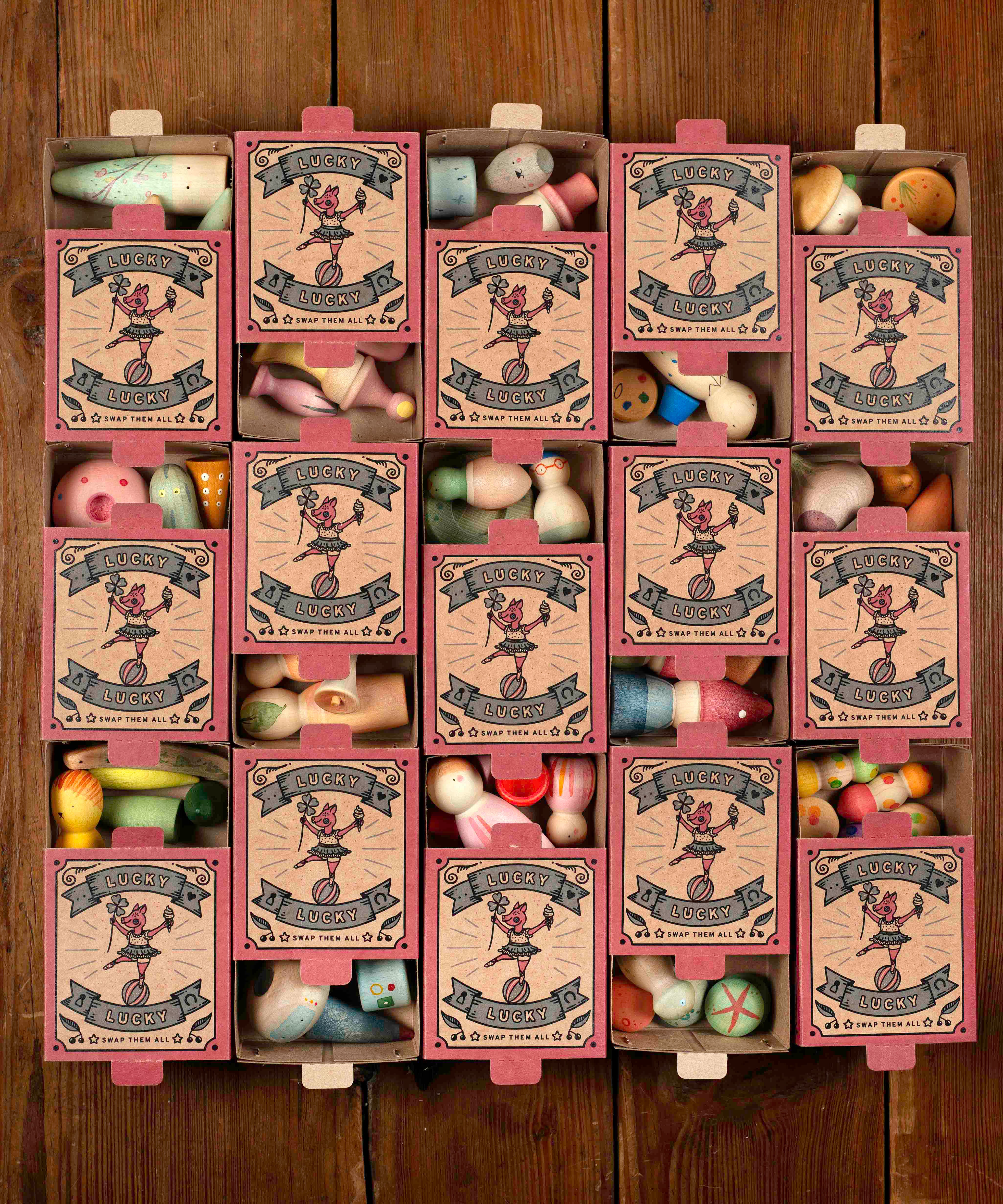A flatlay showing all wooden sets inside the decorative cardboard packaging 