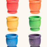 A set of six rainbow mates wooden loose parts. Red, orange, yellow, green, blue and purple. 