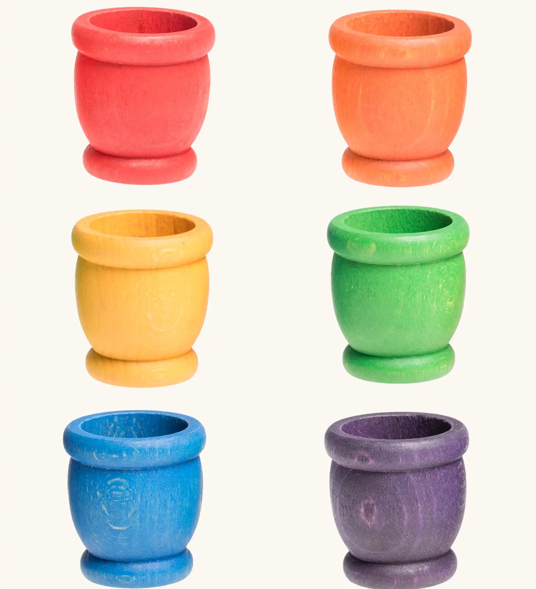 A set of six rainbow mates wooden loose parts. Red, orange, yellow, green, blue and purple. 
