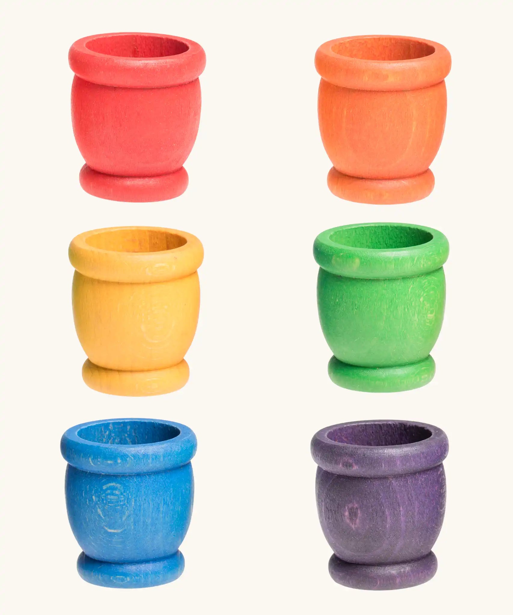 A set of six rainbow mates wooden loose parts. Red, orange, yellow, green, blue and purple. 