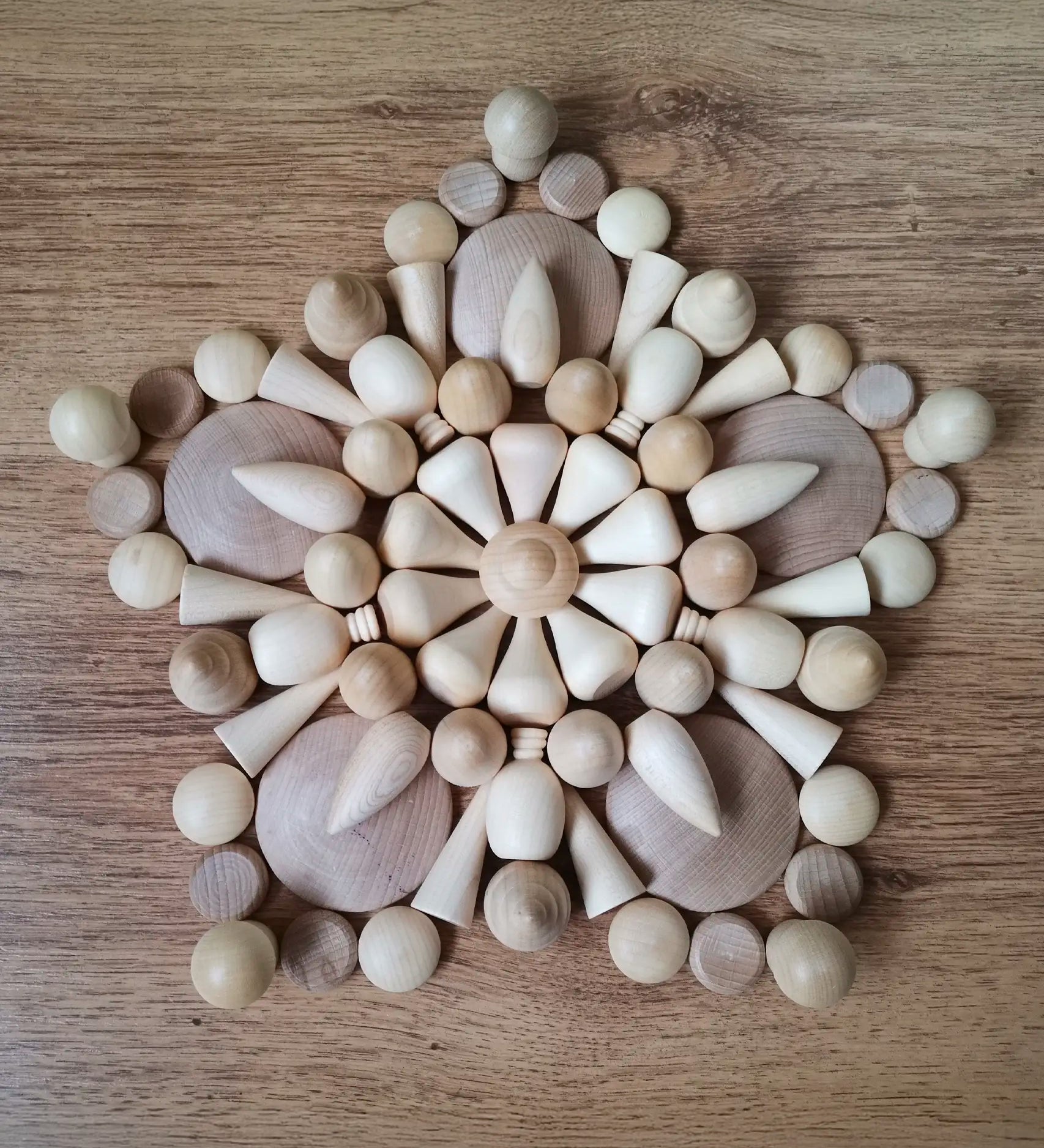 A mandala pattern made from Grapat natural wooden loose pieces