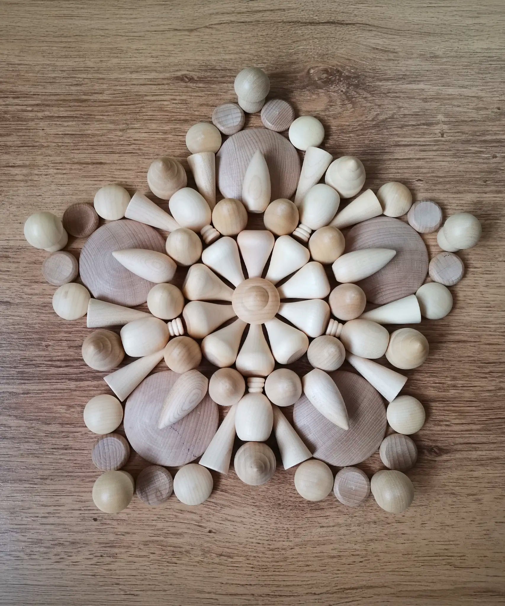A mandala pattern made from Grapat natural wooden loose pieces