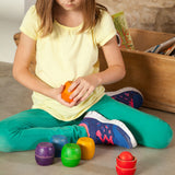 A child playing with the Grapat Bowls & Balls Set. A set of 5 wooden balls and 12 wooden balls. These are perfect for colour matching activities. These wooden toys are part of a wide range of open ended toys available at Babipur.  