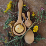 Grapat handmade Wooden Easter Decorations Hop bunny and Peep chick. The chick has been placed in a small wooden spoon whilst the rabbit is paced besides it. 