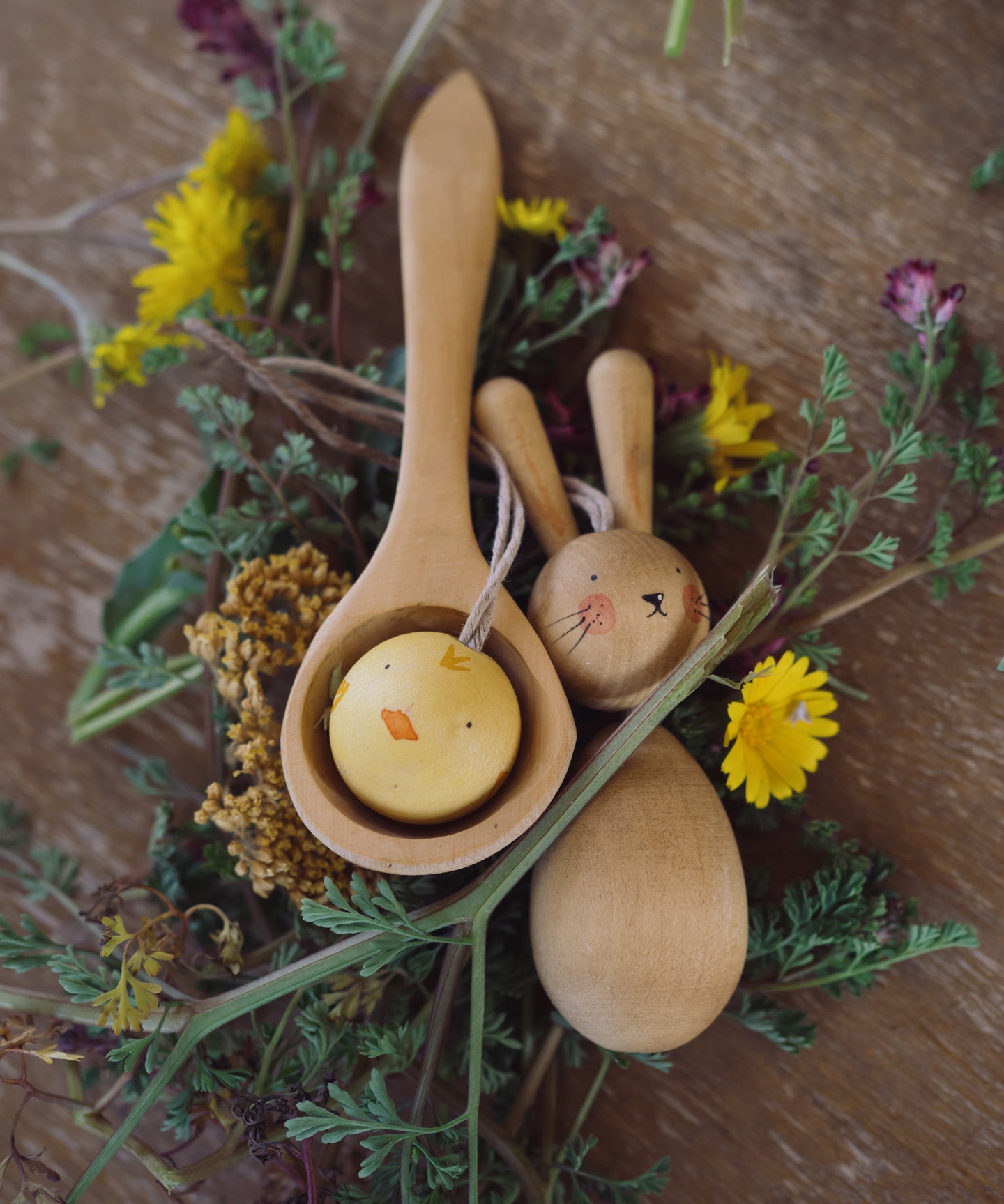 Grapat handmade Wooden Easter Decorations Hop bunny and Peep chick. The chick has been placed in a small wooden spoon whilst the rabbit is paced besides it. 