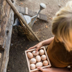 Close up of child holding the Grapat eco-friendly square wooden toy box