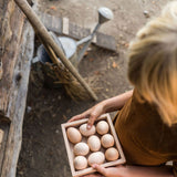Close up of child holding the Grapat eco-friendly square wooden toy box