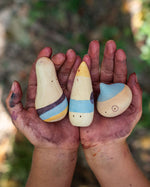 Close up of childs hands covered in paint