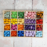 Wooden tinker tray filled with different Grapat mandala pieces in different compartments