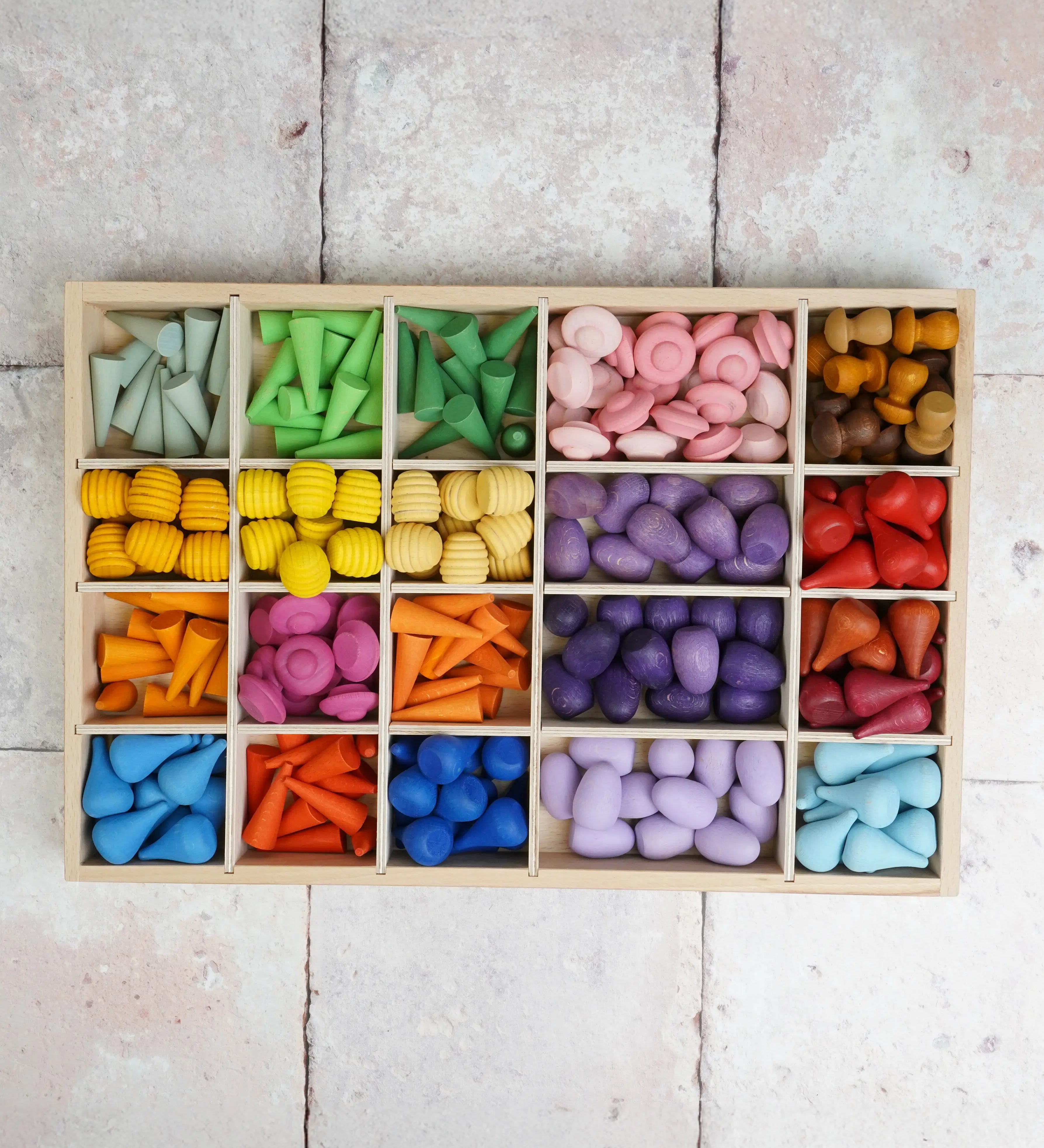 Wooden tinker tray filled with different Grapat mandala pieces in different compartments