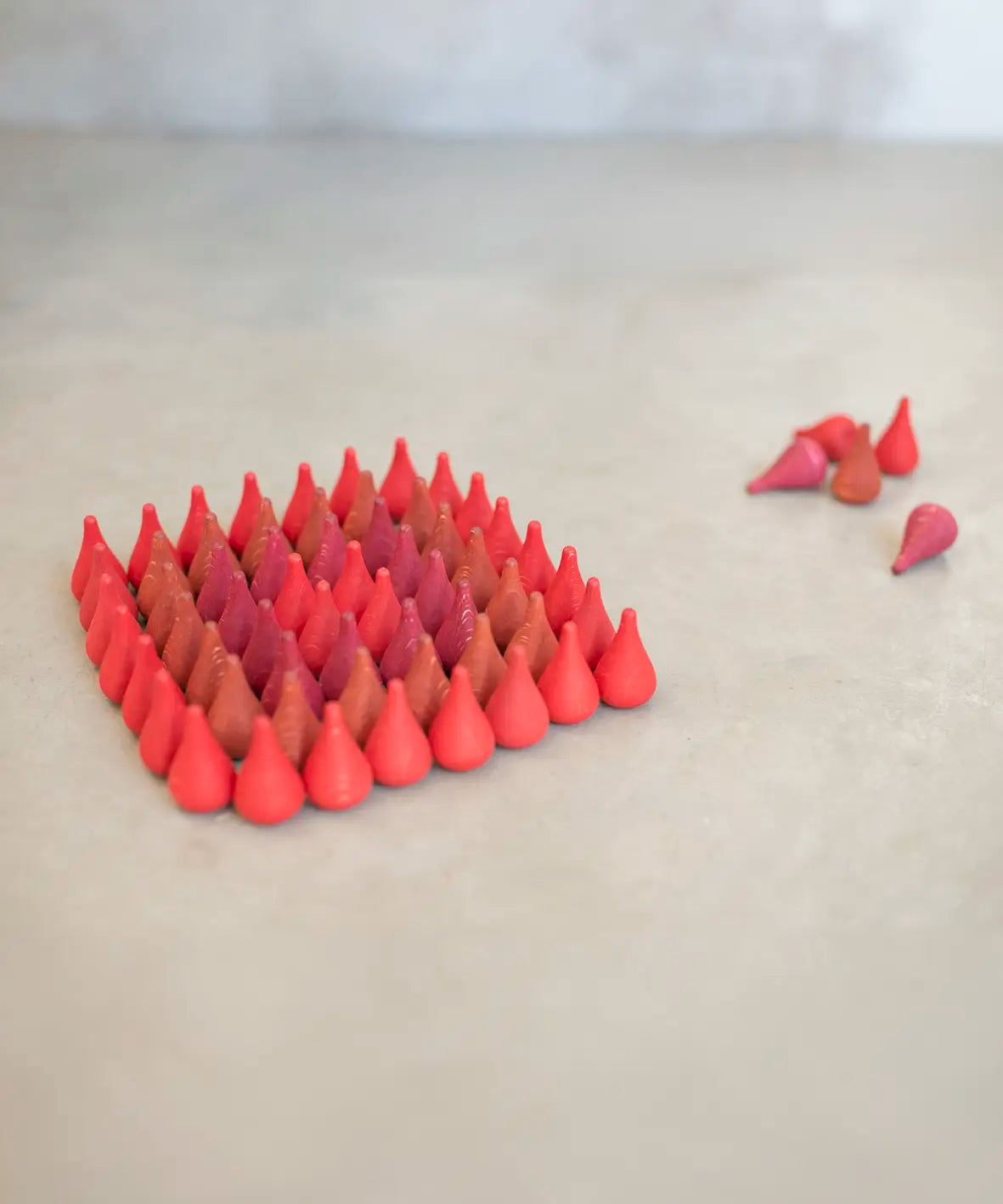 Individual Grapat wooden fire mandala droplet shaped pieces sorted in a diamond shape