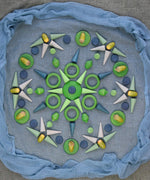 Handcrafted wooden Grapat green mandala loose pieces laid in a decorative mandala pattern