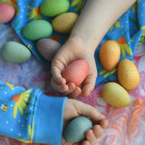 Children's hand picking up Grapat Happy Eggs wooden toys.