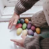 A child collecting the Grapat Happy Eggs Toys together in one pile.