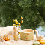 Grapat / Ostheimer Hello Summer wooden figures set showing the peg doll, bowl goose and 2 mandala pieces on a table cloth. 