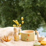 Grapat / Ostheimer Hello Summer wooden figures set showing the peg doll, bowl goose and 2 mandala pieces on a table cloth. 