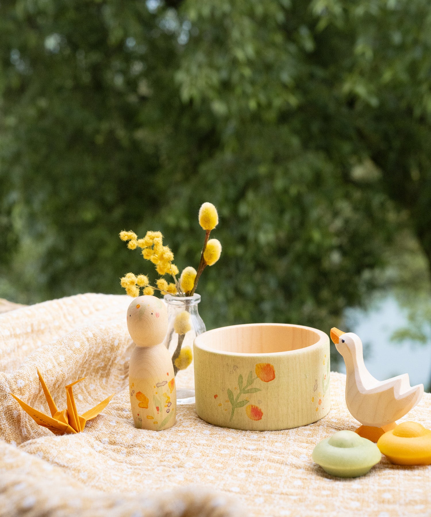Grapat / Ostheimer Hello Summer wooden figures set showing the peg doll, bowl goose and 2 mandala pieces on a table cloth. 
