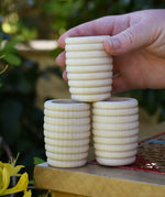 Grapat natural honeycomb cup in an adult's hand.