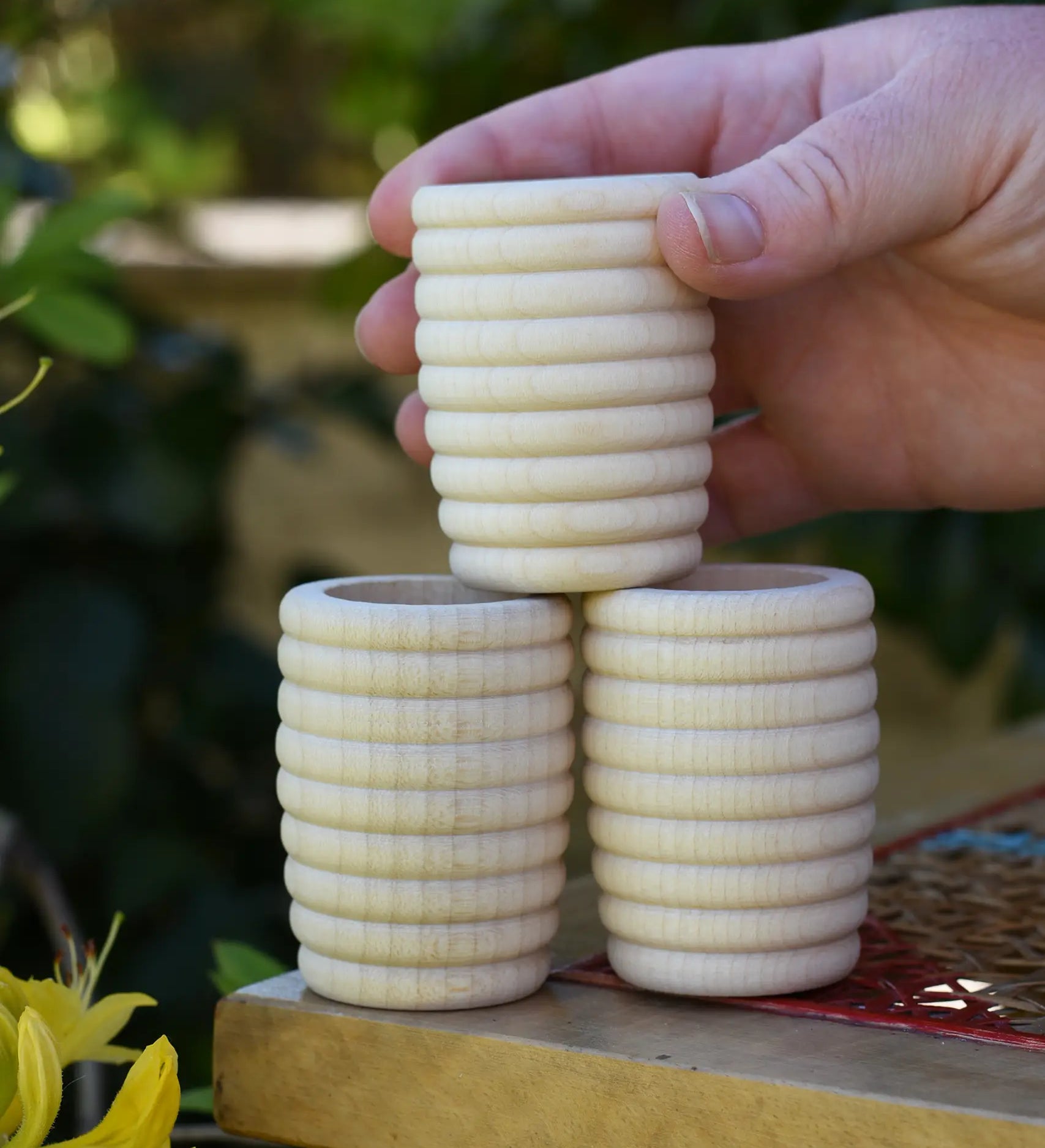 Grapat natural honeycomb cup in an adult's hand.