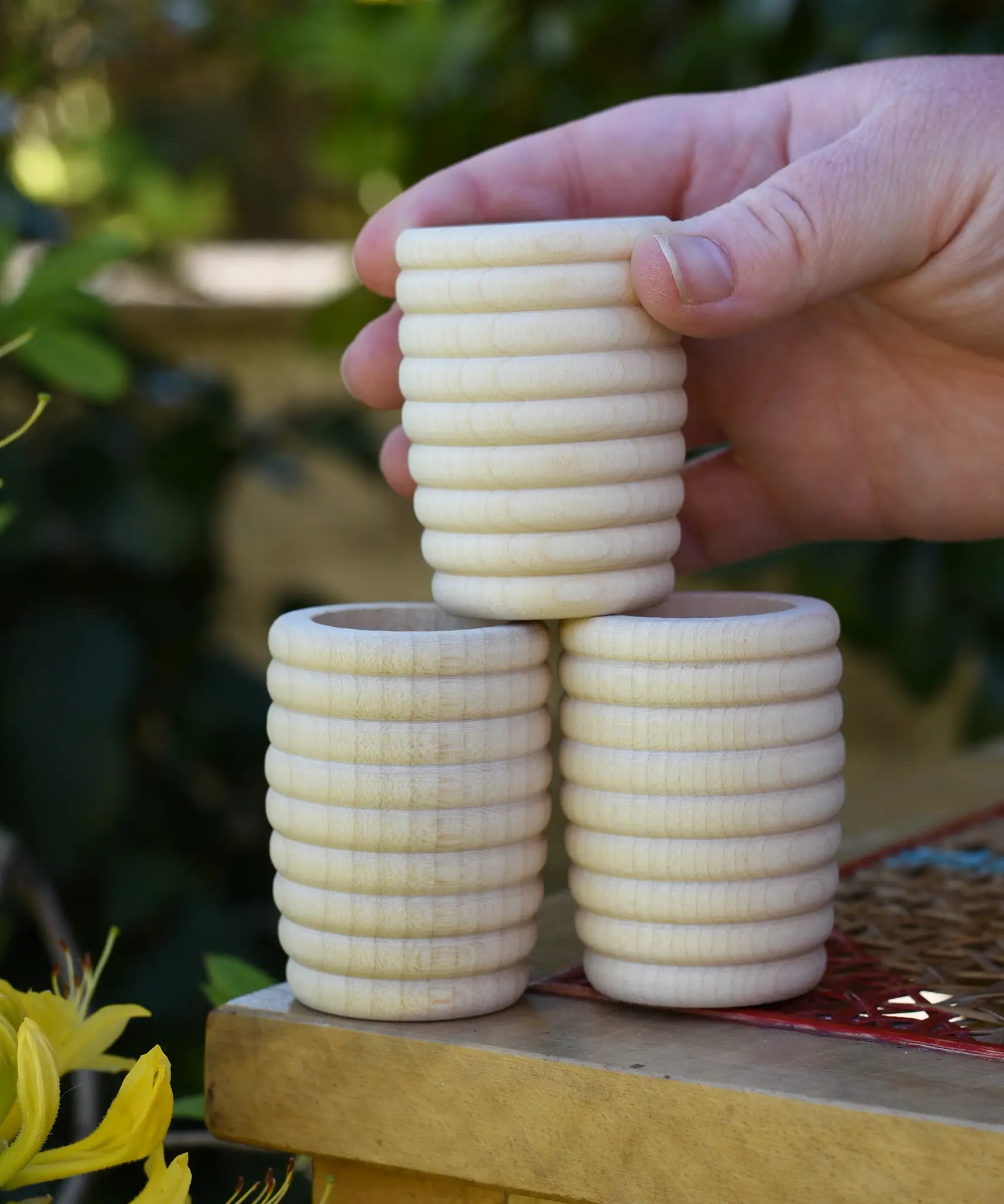 Grapat natural honeycomb cup in an adult's hand.