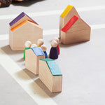 Grapat Nins® and Houses Set including 6 colourful Nin peg people and 6 coordinating colour abstract houses. Houses set up as a village with the Nins having a meeting in the centre. Great for colour matching and imaginary play. White background.