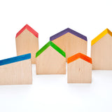 Grapat Six Wooden Houses Set in different simple geometric shapes in natural wood and colourful painted roofs. White background.
